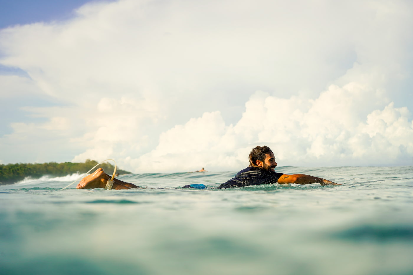 man in the sea surfing